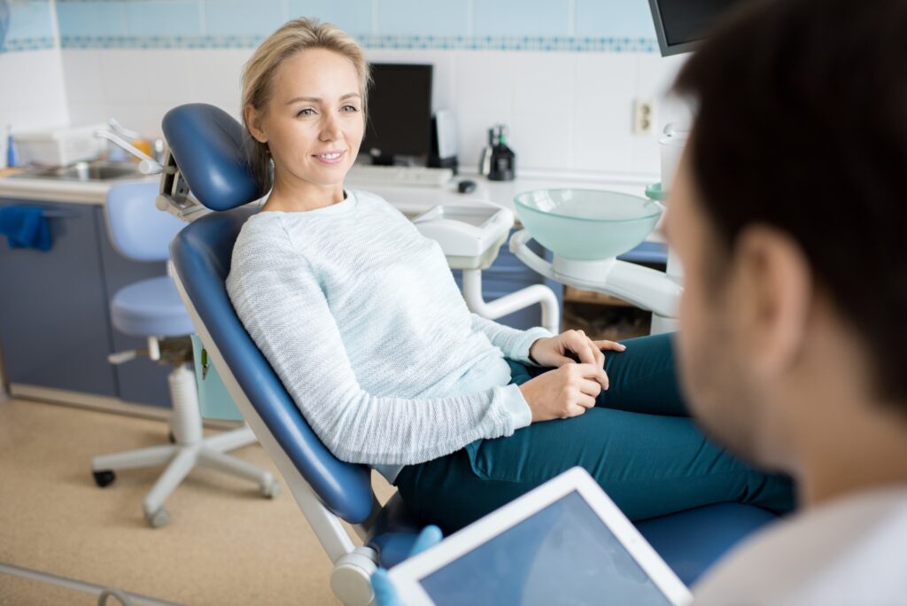 patient smiling from hearing the benefits of the procedure