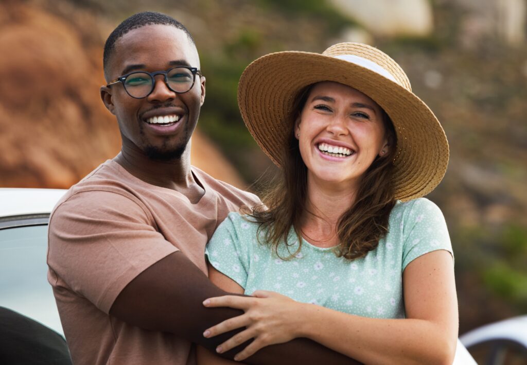 a smiling couple who has gotten back to everyday life after dental bone grafting and dental implant surgery