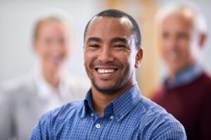 a smiling man who found South Calgary Oral Surgery by searching "dental implants calgary price"