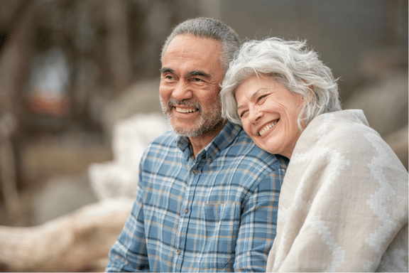 senior couple happy with their choice to replace missing teeth with dental surgery